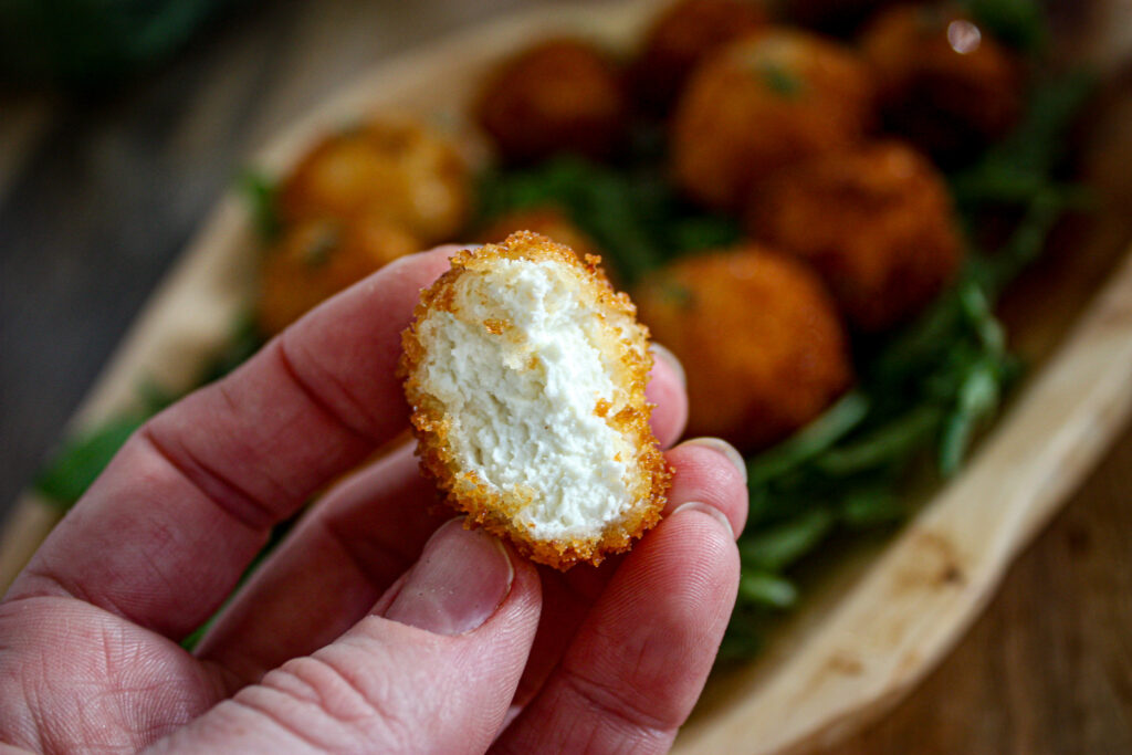 bite of fried goat cheese balls