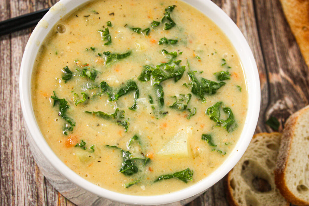bowl of vegan veggie potato kale soup