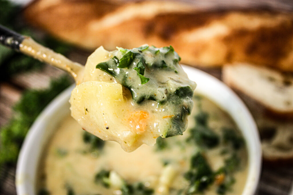 spoon of kale and potato soup