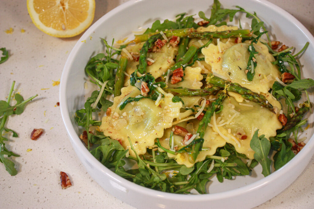 plate of ravioli and aspragus