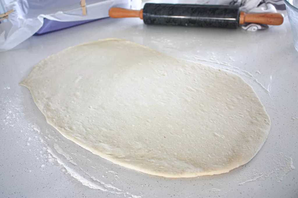 rolling out cinnamon roll dough